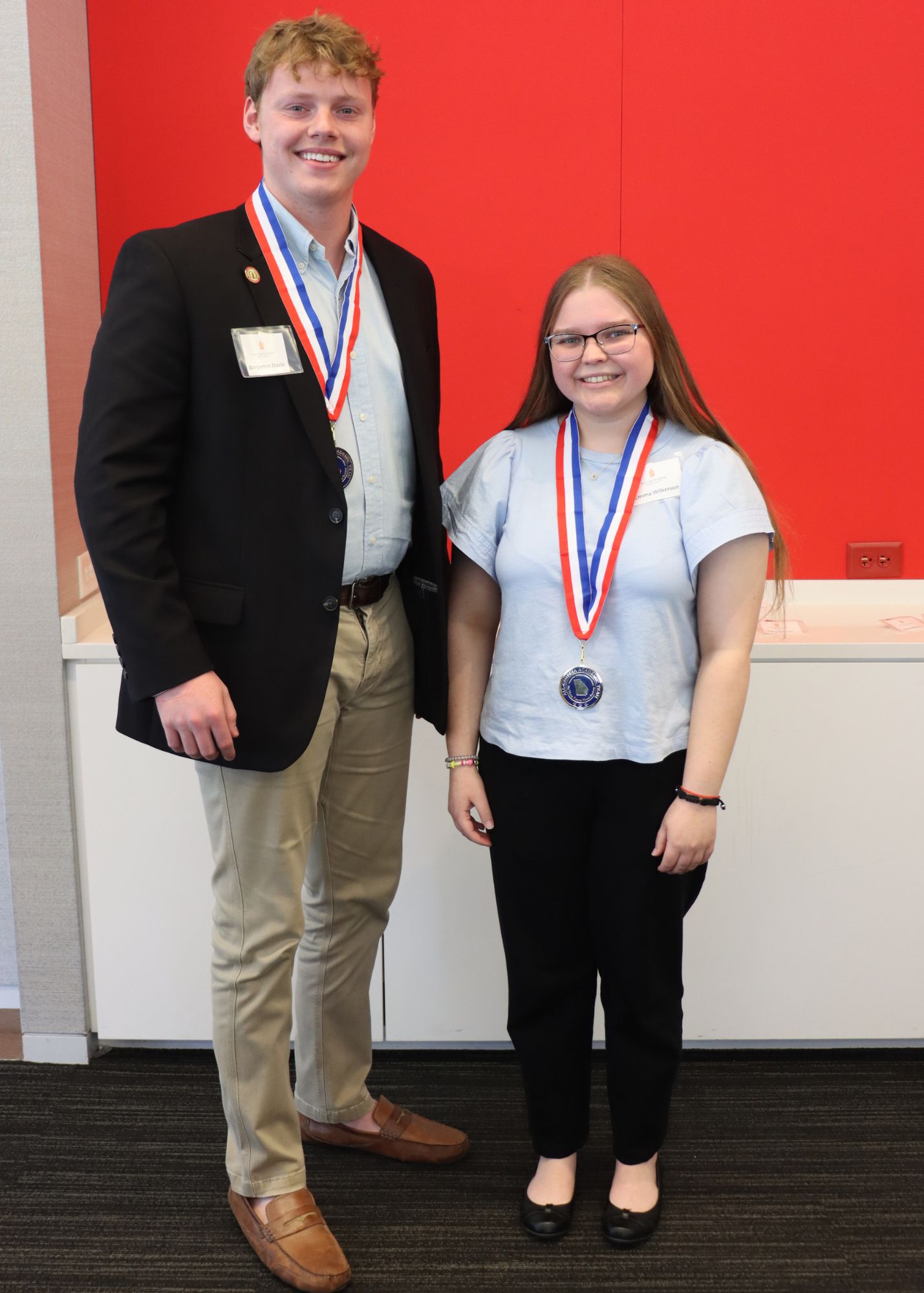 Two students with their medallions